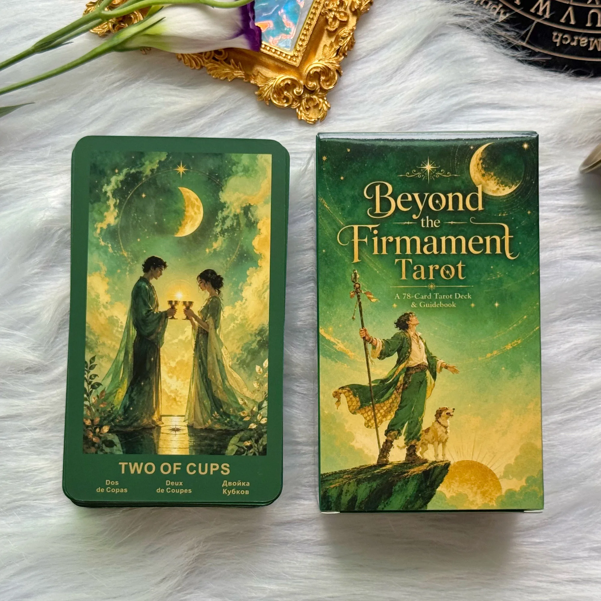 Carte Deux de Coupes illustrée devant le coffret vert du tarot Beyond the Firmament